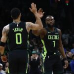 Feb 28, 2025; Boston, Massachusetts, USA; Boston Celtics guard Jaylen Brown (7) high fives forward Jayson Tatum (0) after the Cleveland Cavaliers called a timeout during the first quarter at TD Garden. Mandatory Credit: Winslow Townson-Imagn Images