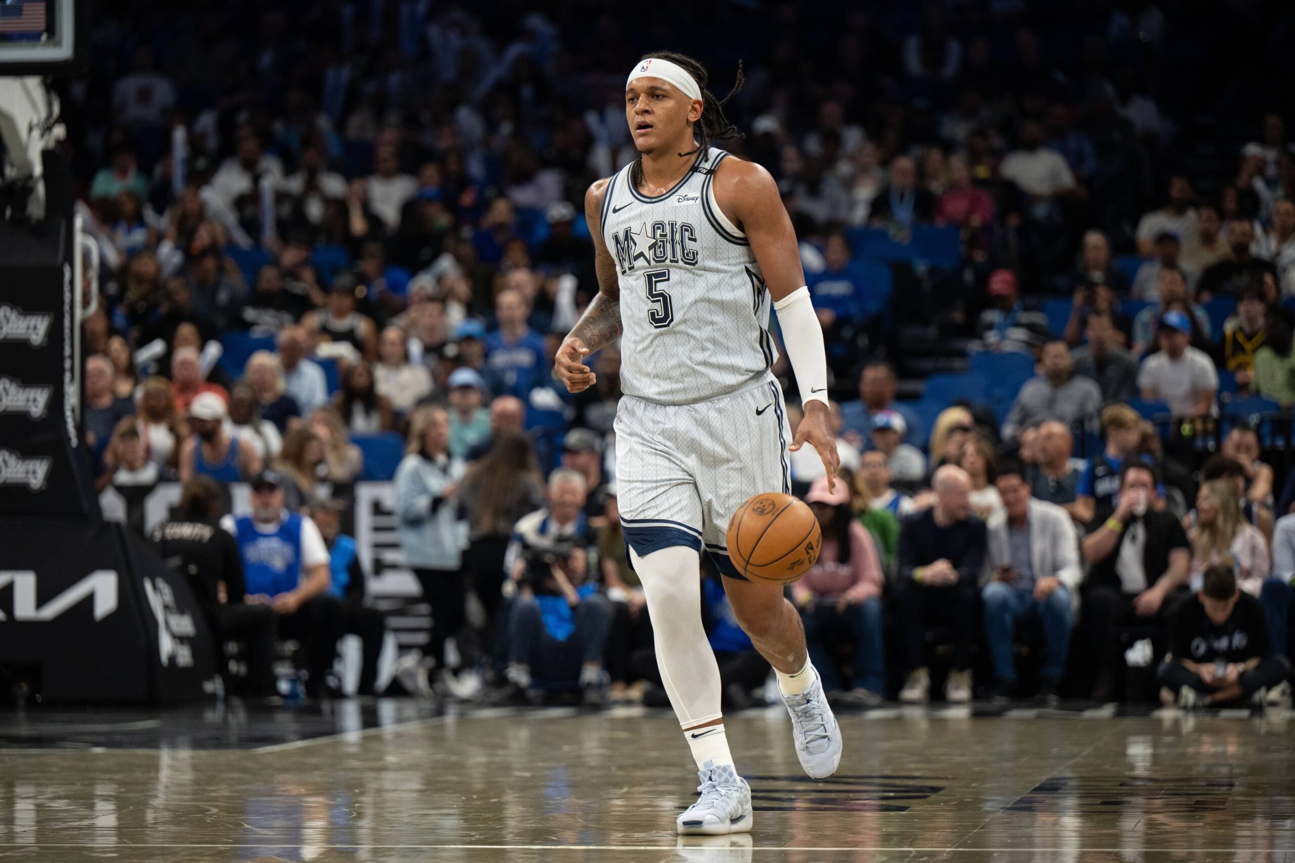 Mar 27, 2025; Orlando, Florida, USA; Orlando Magic forward Paolo Banchero (5) dribbles the ball against the Dallas Mavericks in the third quarter at Kia Center. Mandatory Credit: Jeremy Reper-Imagn Images