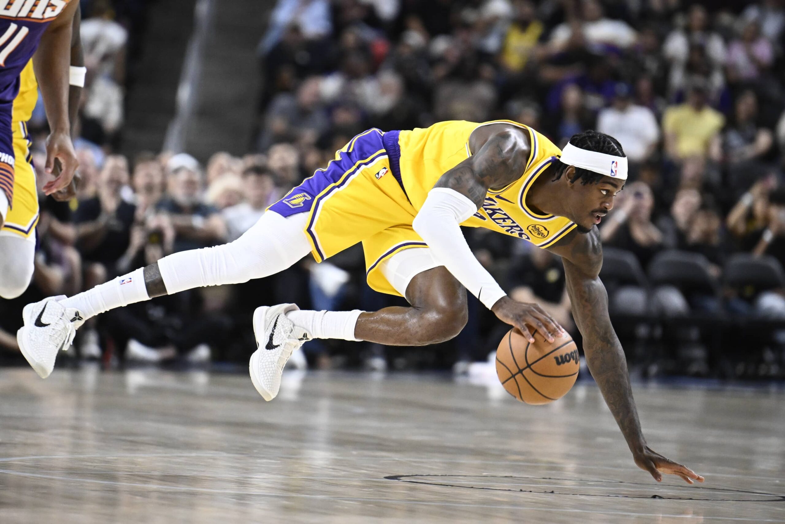 Oct 3, 2025; Palm Desert, California, USA; Los Angeles Lakers forward Jarred Vanderbilt (2) dives for a loose ball during the first half against the Phoenix Suns at Acrisure Arena. Mandatory Credit: Denis Poroy-Imagn Images