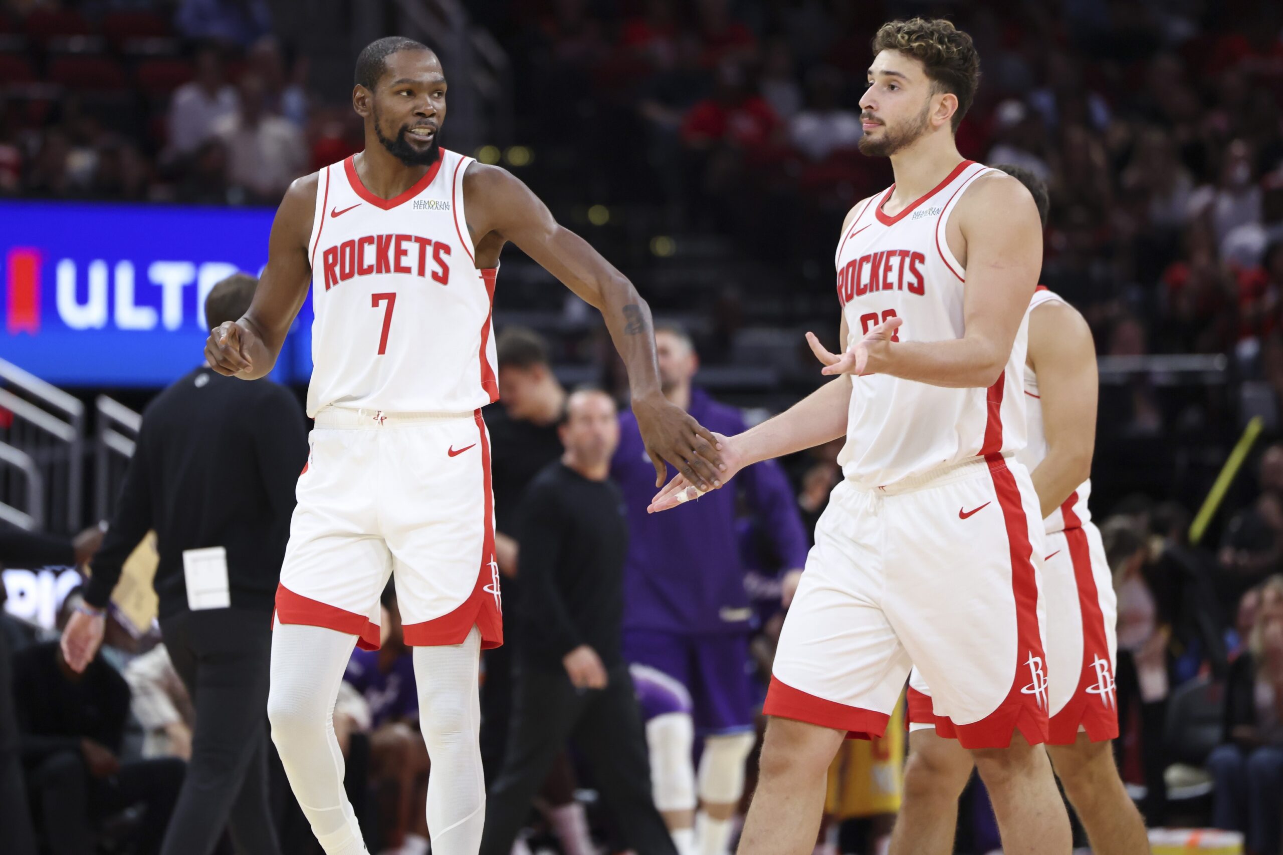 Oct 8, 2025; Houston, Texas, USA; Houston Rockets forward Kevin Durant (7) reacts with center Alperen Sengun (28) after a play during the third quarter against the Utah Jazz at Toyota Center. Mandatory Credit: Troy Taormina-Imagn Images