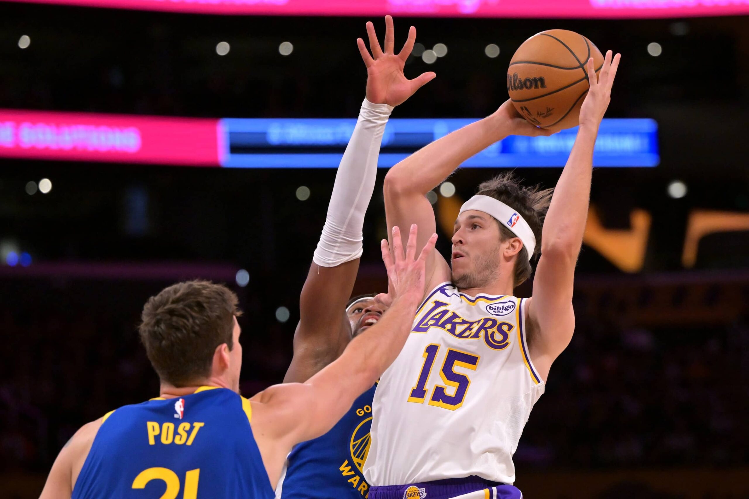 Oct 12, 2025; Los Angeles, California, USA; Los Angeles Lakers guard Austin Reaves (15) is defended by Golden State Warriors center Quinten Post (21) in the first half at Crypto.com Arena. Mandatory Credit: Jayne Kamin-Oncea-Imagn Images