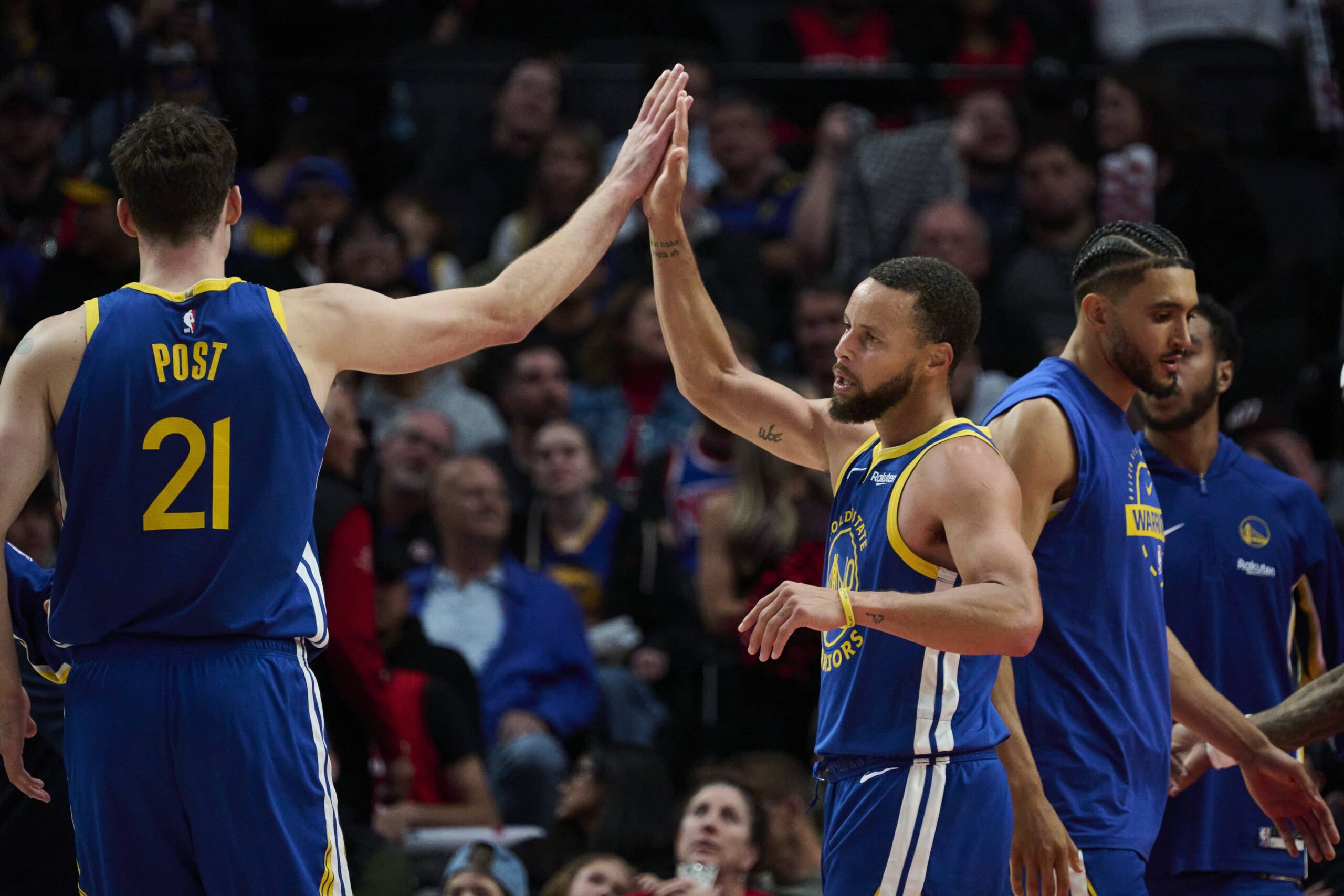 Oct 14, 2025; Portland, Oregon, USA; Golden State Warriors guard Stephen Curry (30) high fives center Quinten Post (21) during the second half against th Portland Trail Blazers at Moda Center. Mandatory Credit: Troy Wayrynen-Imagn Images