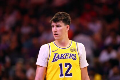 Oct 14, 2025; Phoenix, Arizona, USA; Los Angeles Lakers forward Jake LaRavia (12) against the Phoenix Suns during an NBA preseason game at Mortgage Matchup Center. Mandatory Credit: Mark J. Rebilas-Imagn Images