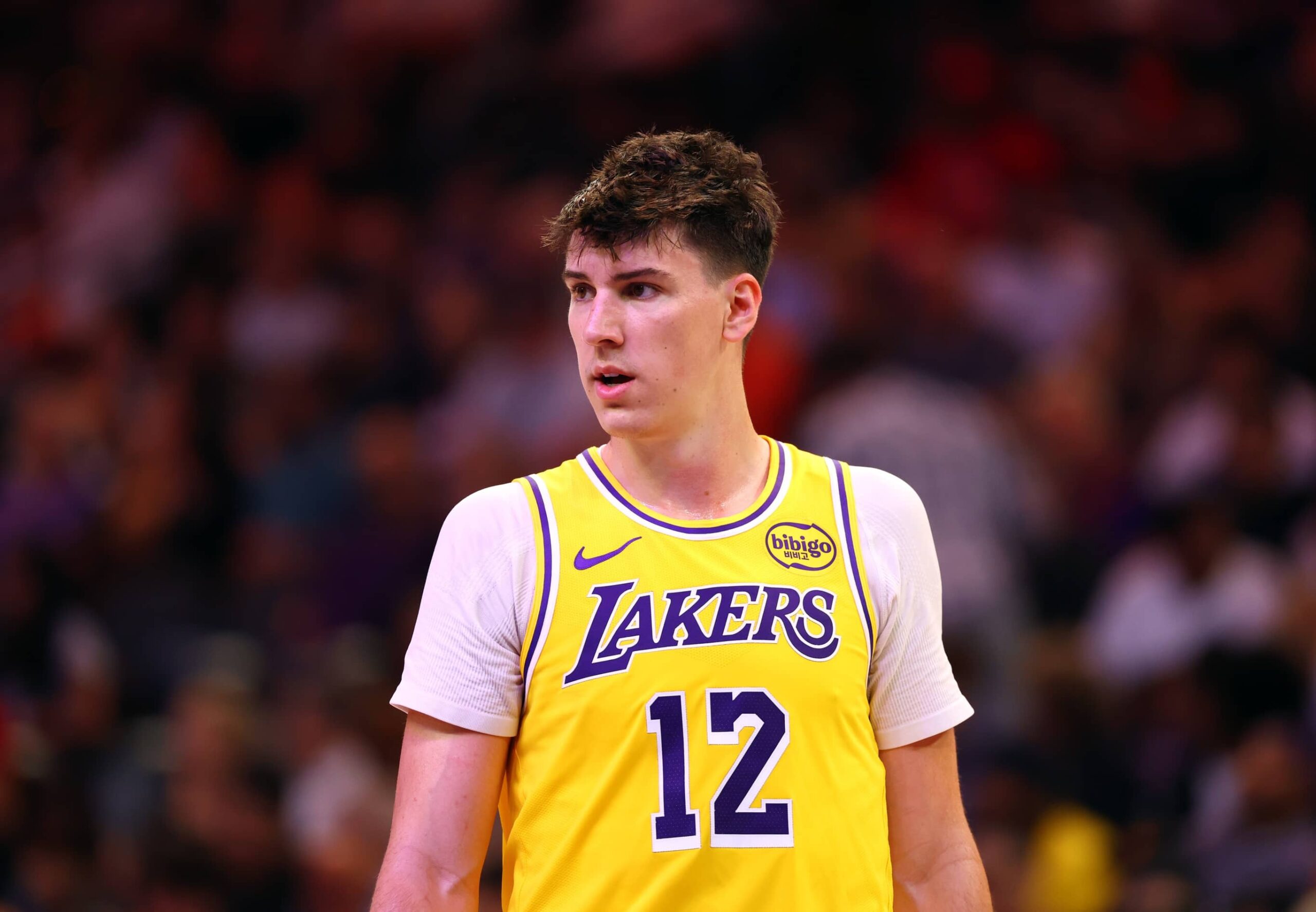 Oct 14, 2025; Phoenix, Arizona, USA; Los Angeles Lakers forward Jake LaRavia (12) against the Phoenix Suns during an NBA preseason game at Mortgage Matchup Center. Mandatory Credit: Mark J. Rebilas-Imagn Images