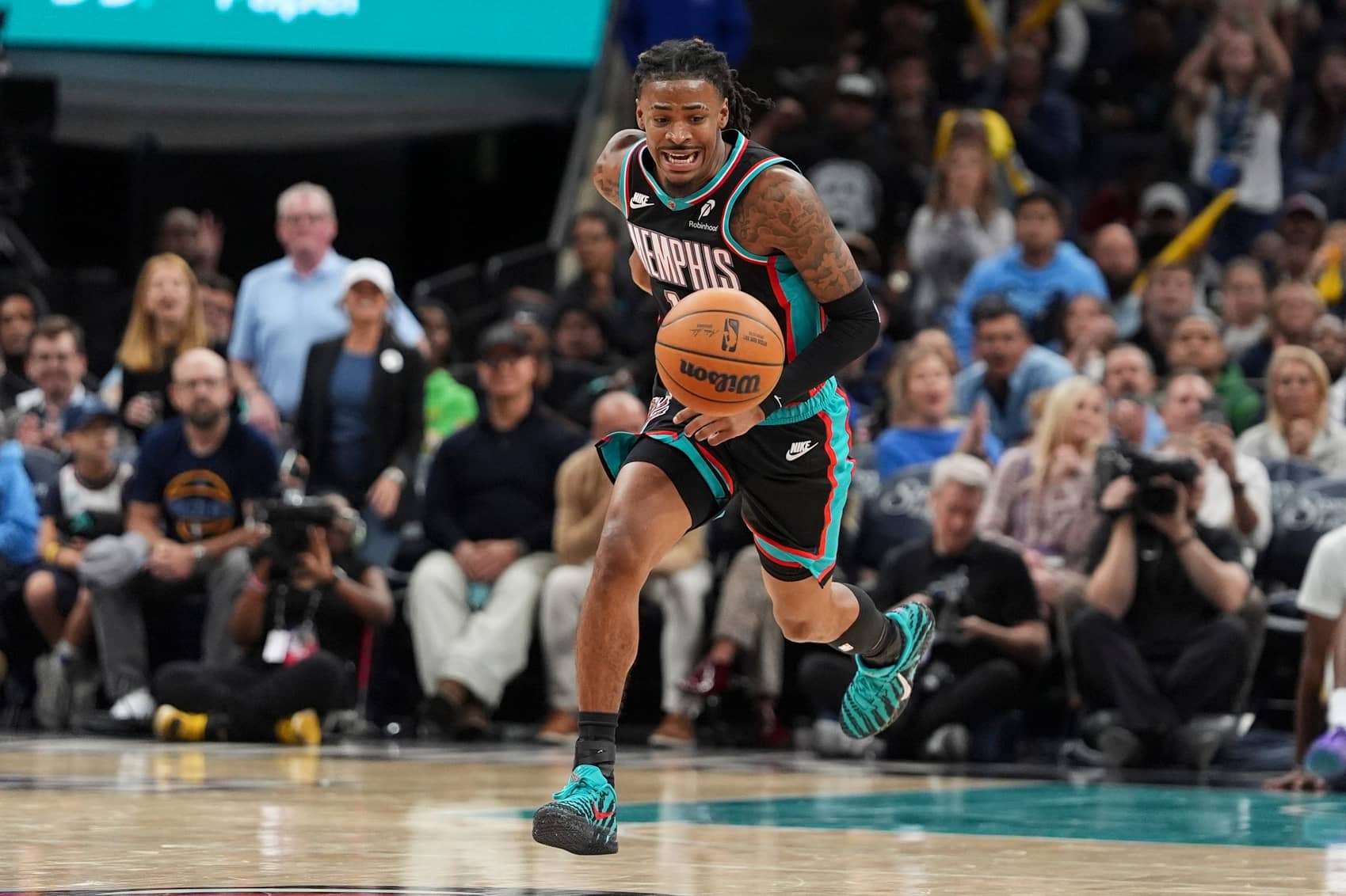 Grizzlies' Ja Morant (12) drives down the court during the home opener against the New Orleans Pelicans at FedExForum on October 22, 2025.