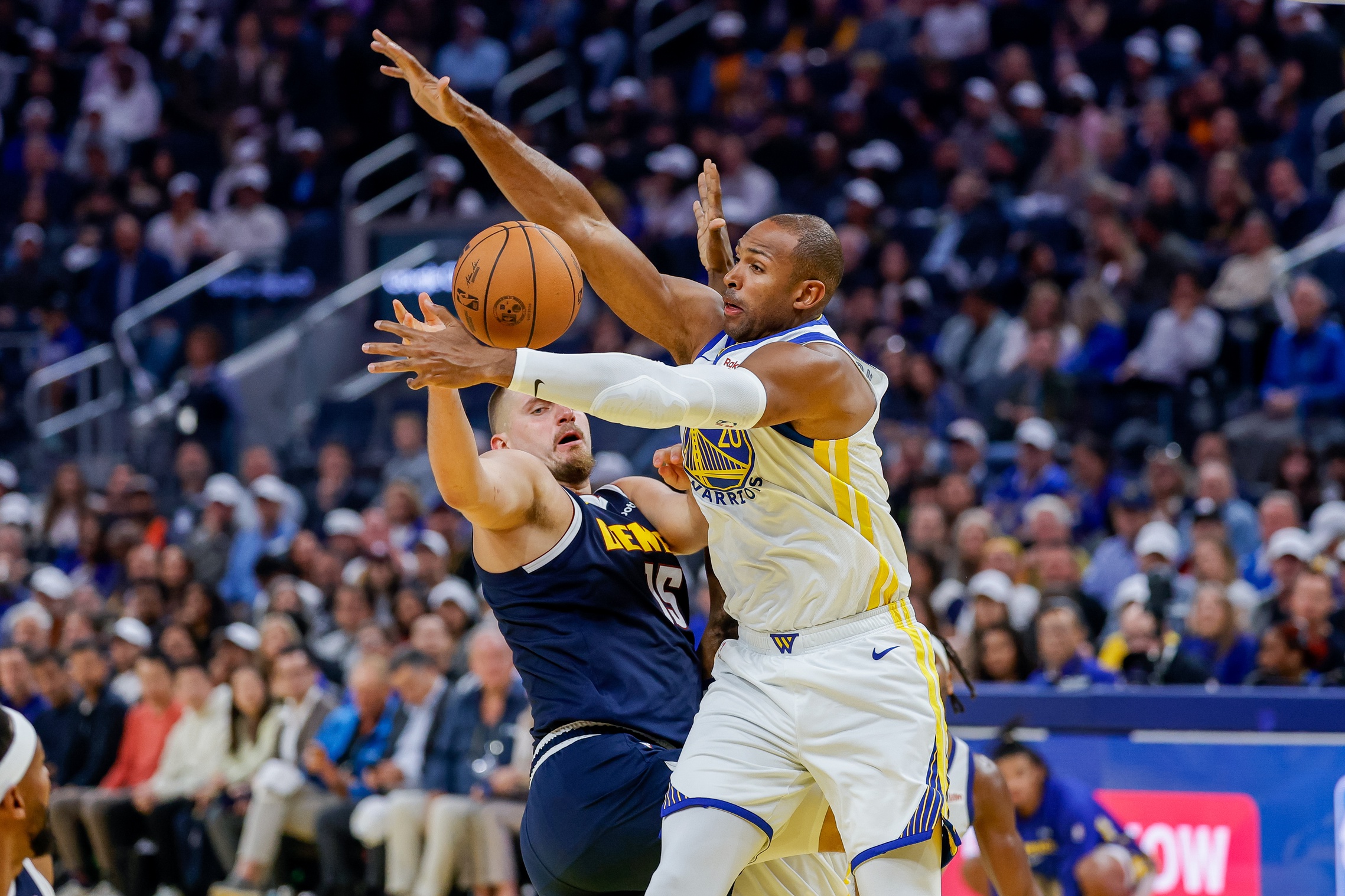 Oct 23, 2025; San Francisco, California, USA; Denver Nuggets center Nikola Jokic (15) is defended by Golden State Warriors center Al Horford (20) during the second quarter at Chase Center. Mandatory Credit: Bob Kupbens-Imagn Images