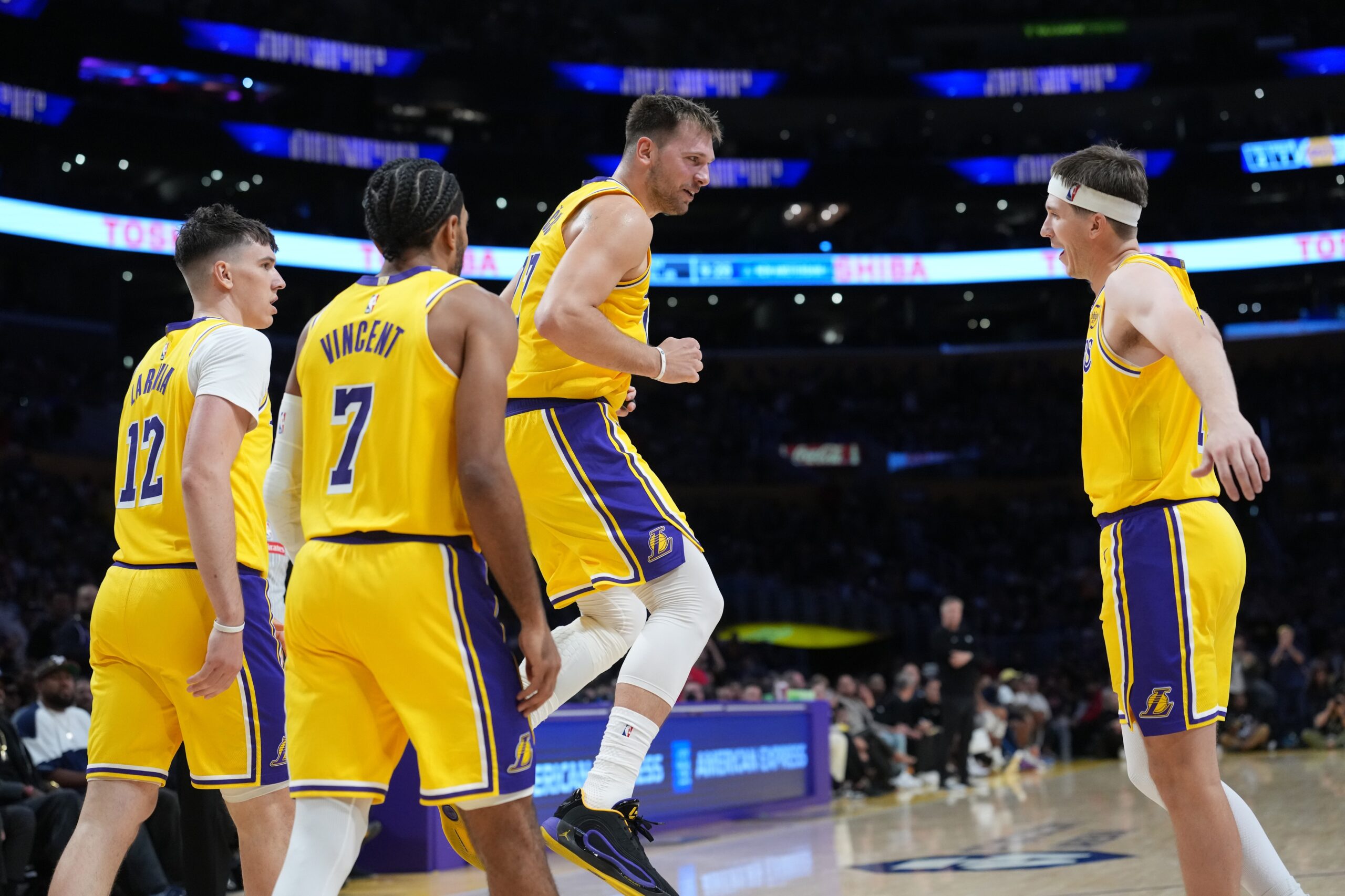 Oct 24, 2025; Los Angeles, California, USA; Los Angeles Lakers guard Luka Doncic (77) celebrates with forward Jake LaRavia (12), guard Gabe Vincent (7) and guard Austin Reaves (15) in the second half against the Minnesota Timberwolves at Crypto.com Arena. Mandatory Credit: Kirby Lee-Imagn Images