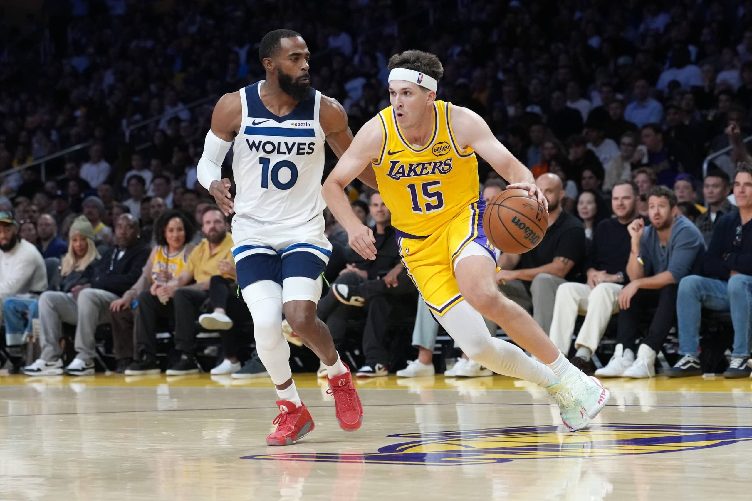 Oct 24, 2025; Los Angeles, California, USA; Los Angeles Lakers guard Austin Reaves (15) dribbles the ball against Minnesota Timberwolves guard Mike Conley (10) in the second half at Crypto.com Arena. Mandatory Credit: Kirby Lee-Imagn Images