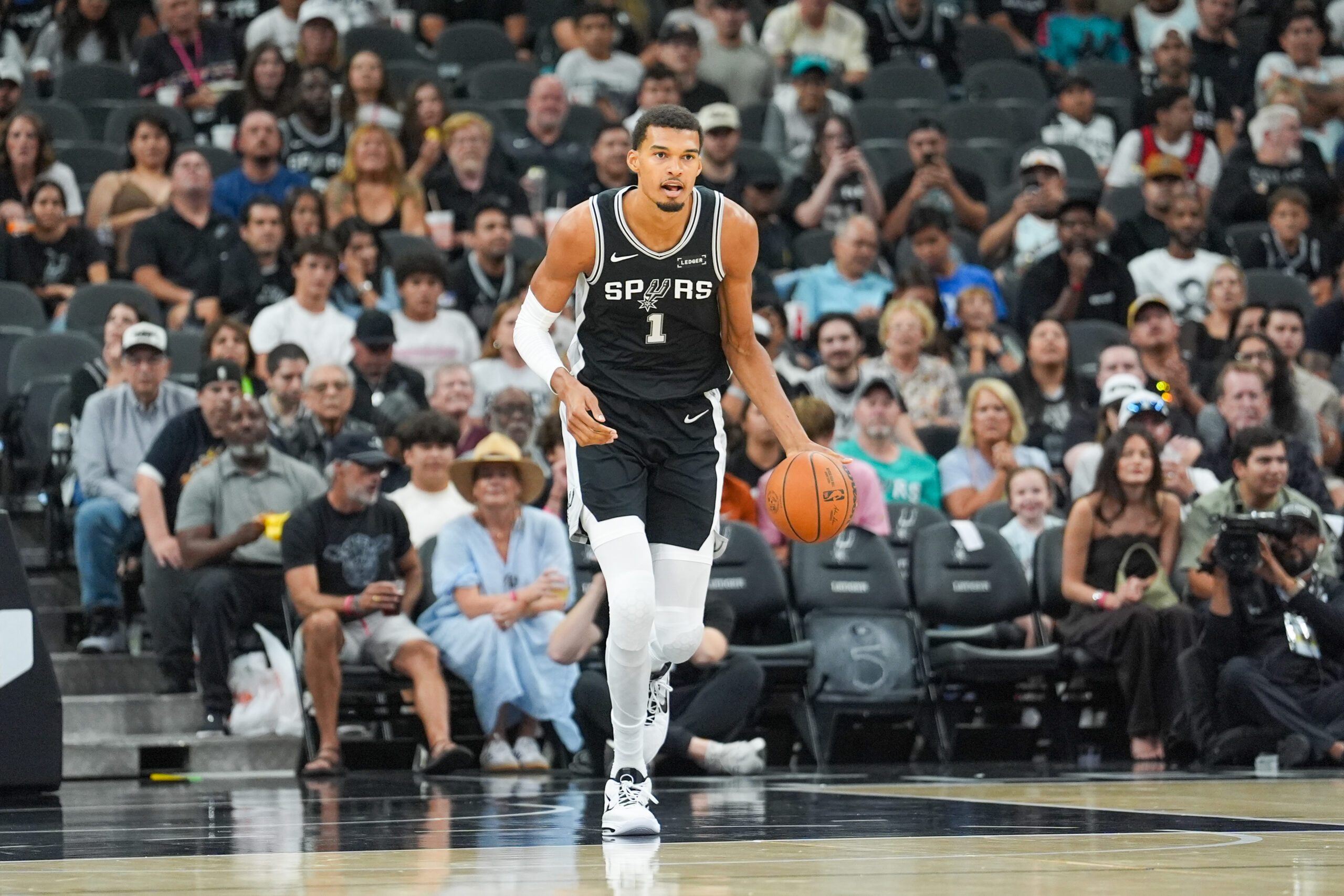 Oct 27, 2025; San Antonio, Texas, USA; San Antonio Spurs forward/center Victor Wembanyama (1) dribbles up the court in the first half against the Toronto Raptors at Frost Bank Center. Mandatory Credit: Daniel Dunn-Imagn Images