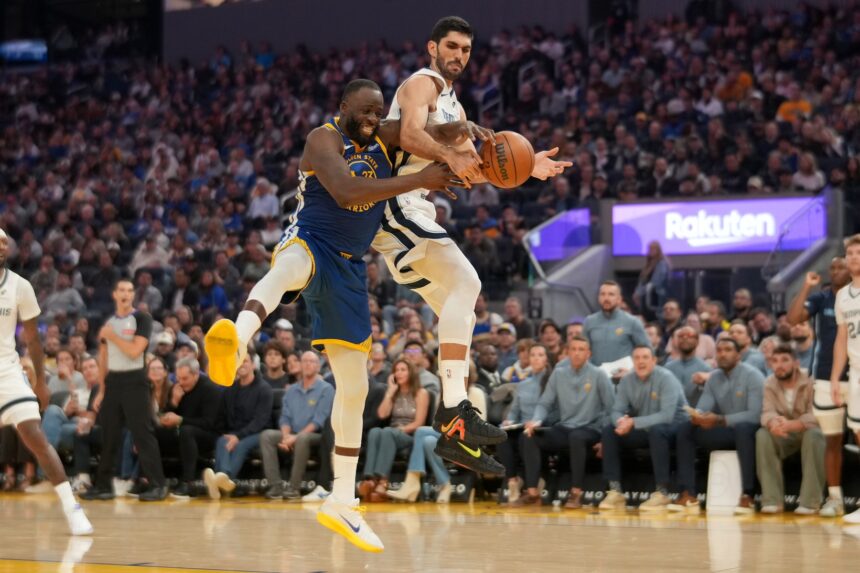 Oct 27, 2025; San Francisco, California, USA; Golden State Warriors forward Draymond Green (23) and Memphis Grizzlies forward Santi Aldama (7) battle for control of a rebound in the second quarter at the Chase Center. Mandatory Credit: Cary Edmondson-Imagn Images