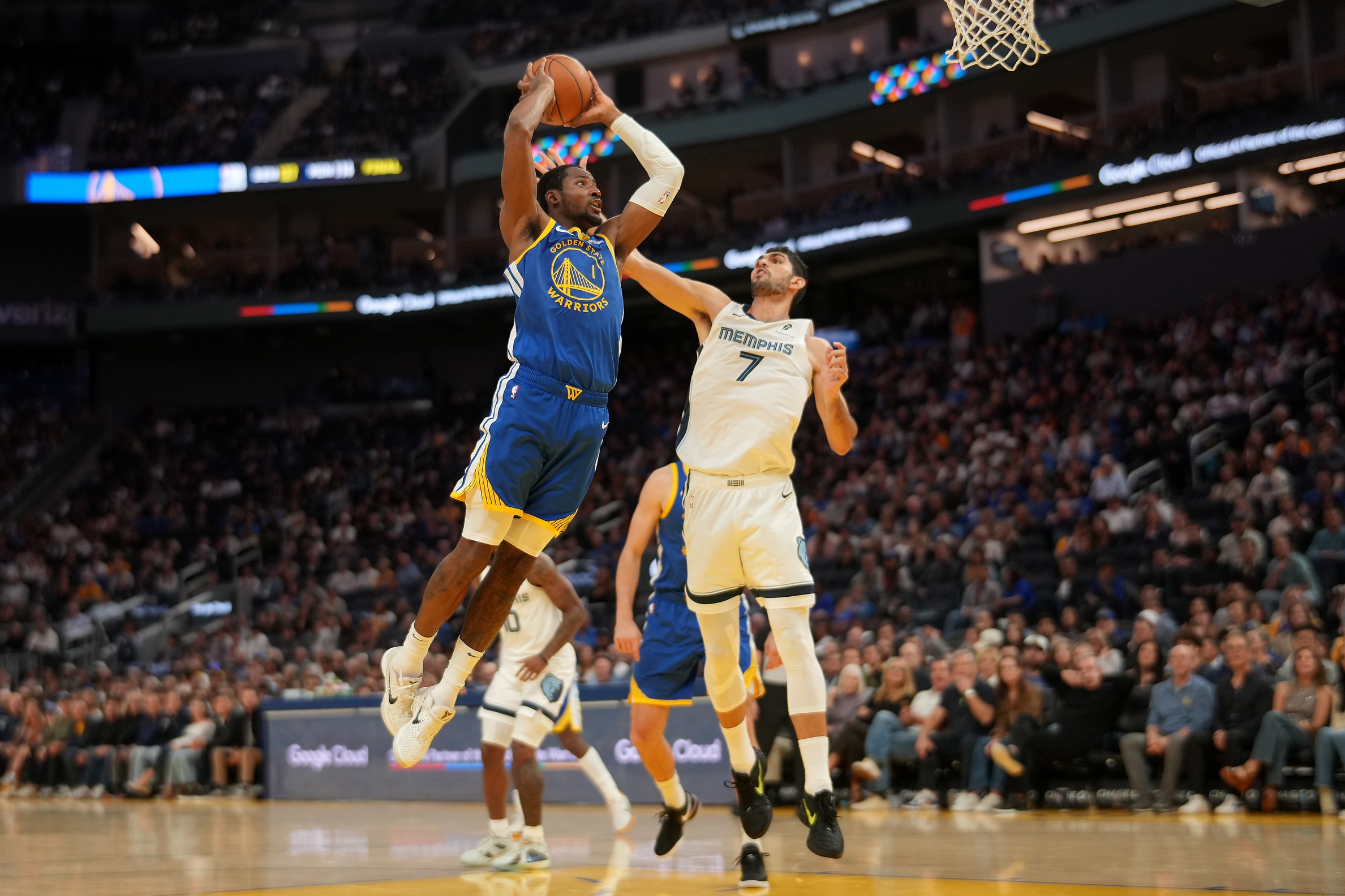 Oct 27, 2025; San Francisco, California, USA; Golden State Warriors forward Jonathan Kuminga (1) dunks the ball over Memphis Grizzlies forward Santi Aldama (7) in the fourth quarter at the Chase Center. Mandatory Credit: Cary Edmondson-Imagn Images