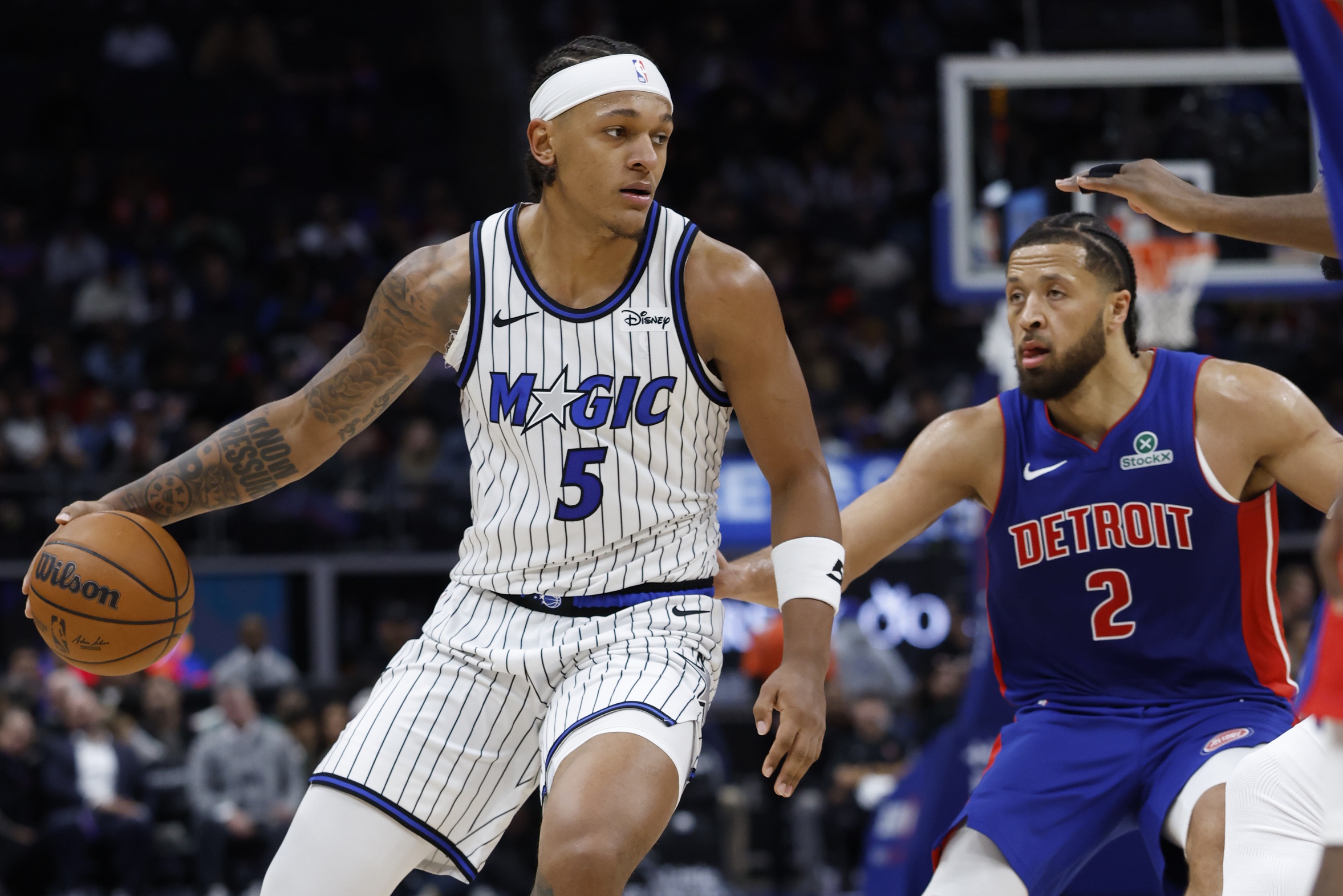 Oct 29, 2025; Detroit, Michigan, USA; Orlando Magic forward Paolo Banchero (5) dribbles while defended by Detroit Pistons guard Cade Cunningham (2) in the first half at Little Caesars Arena. Mandatory Credit: Rick Osentoski-Imagn Images