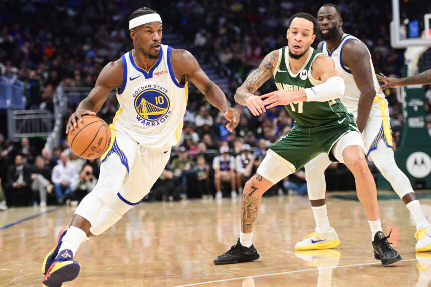 Oct 30, 2025; Milwaukee, Wisconsin, USA; Golden State Warriors forward Jimmy Butler (10) drives for the basket against Milwaukee Bucks forward Amir Coffey (17) in the second quarter at Fiserv Forum. Mandatory Credit: Benny Sieu-Imagn Images