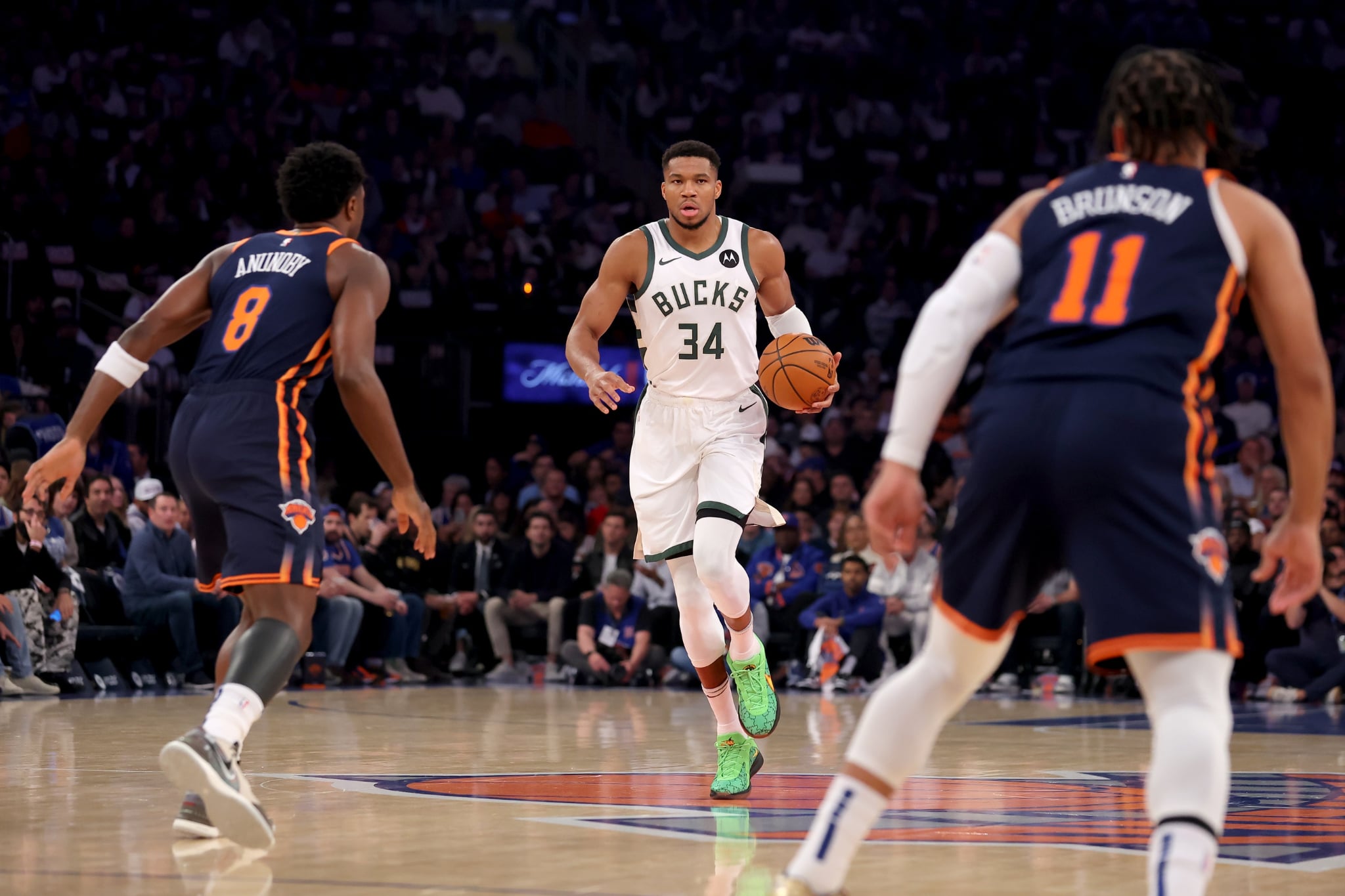 Nov 8, 2024; New York, New York, USA; Milwaukee Bucks forward Giannis Antetokounmpo (34) brings the ball up court against New York Knicks forward OG Anunoby (😎 and guard Jalen Brunson (11) during the first quarter at Madison Square Garden. Mandatory Credit: Brad Penner-Imagn Images