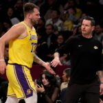 Brooklyn, New York, USA; Los Angeles Lakers guard Luka Doncic (77) high fives head coach JJ Redick during the first quarter against the Brooklyn Nets at Barclays Center. Mandatory Credit: Brad Penner-Imagn Images