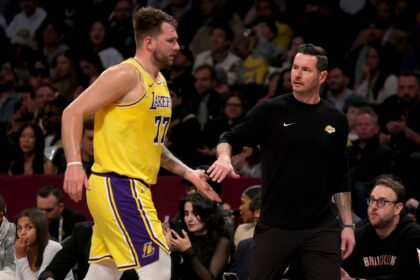 Brooklyn, New York, USA; Los Angeles Lakers guard Luka Doncic (77) high fives head coach JJ Redick during the first quarter against the Brooklyn Nets at Barclays Center. Mandatory Credit: Brad Penner-Imagn Images