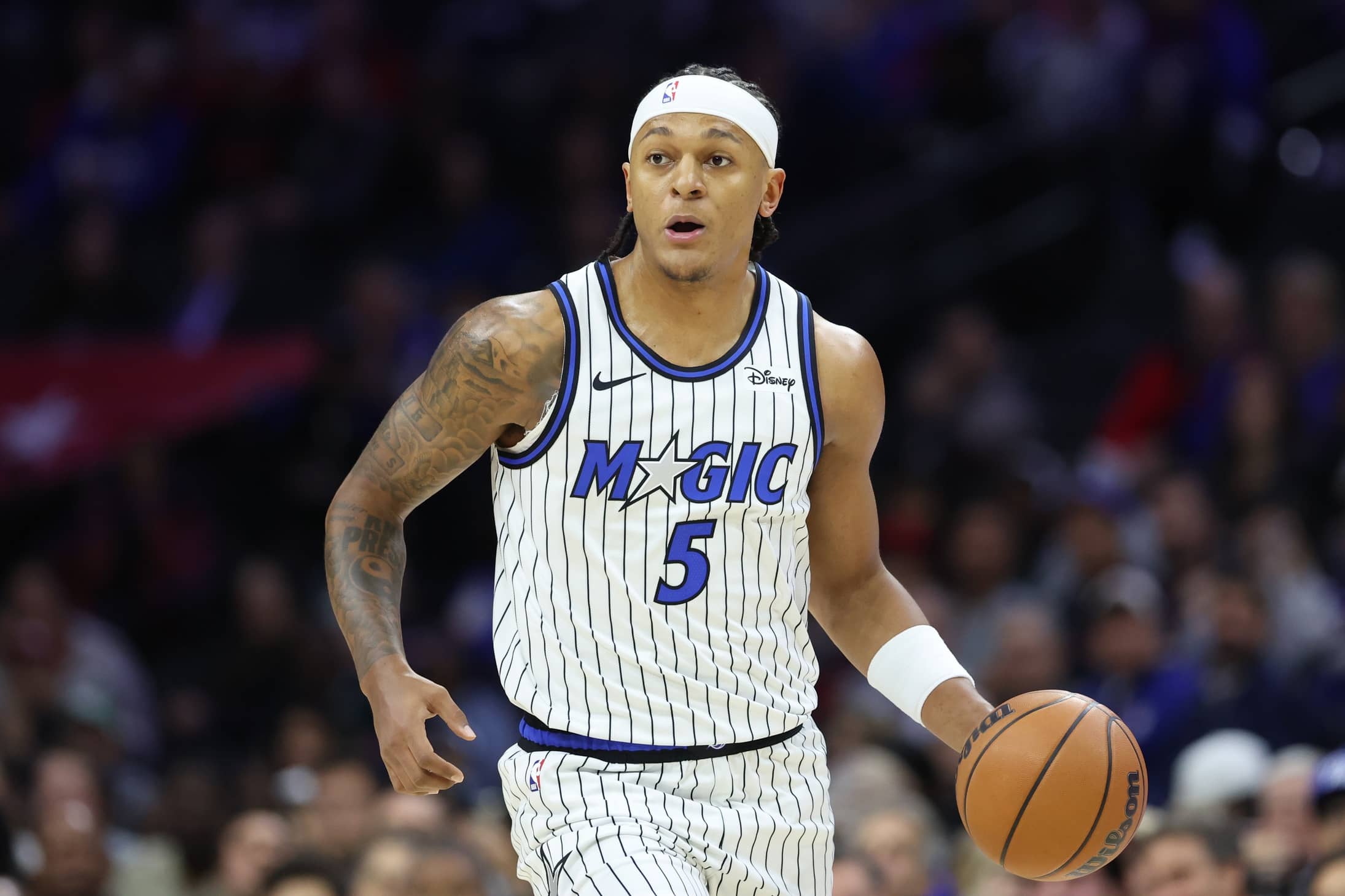 Philadelphia, Pennsylvania, USA; Orlando Magic forward Paolo Banchero (5) dribbles the ball against the Philadelphia 76ers during the first quarter at Xfinity Mobile Arena. Mandatory Credit: Bill Streicher-Imagn Images