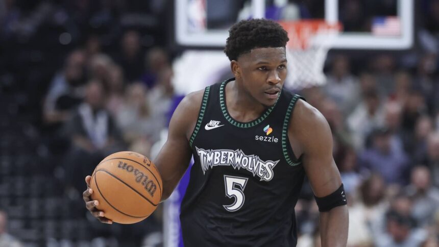 Minnesota Timberwolves guard Anthony Edwards (5) brings the ball up the court against the Utah Jazz during the second half at Delta Center.