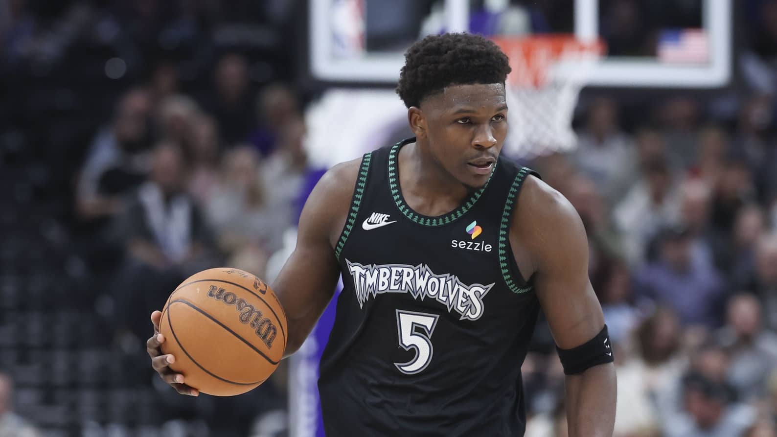 Minnesota Timberwolves guard Anthony Edwards (5) brings the ball up the court against the Utah Jazz during the second half at Delta Center.