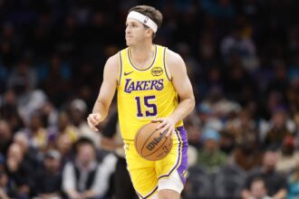 Los Angeles Lakers guard Austin Reaves (15) brings the ball up the court during the second quarter against the Charlotte Hornets at Spectrum Center.