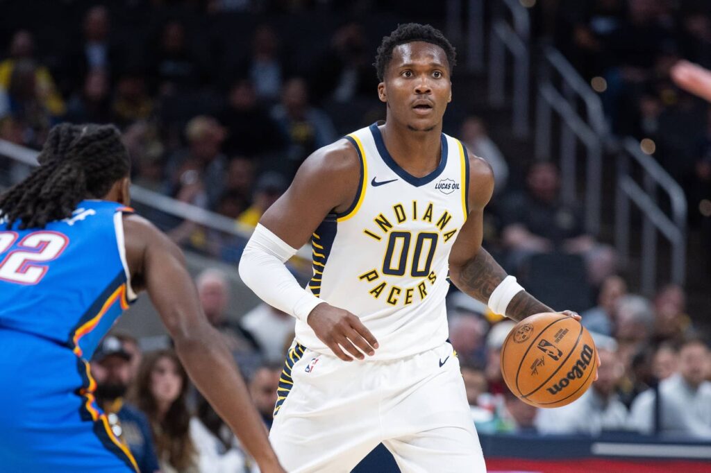 Indiana Pacers guard/forward Bennedict Mathurin (00) dribbles the ball while Oklahoma City Thunder guard Cason Wallace (22) defends in the first half at Gainbridge Fieldhouse.
