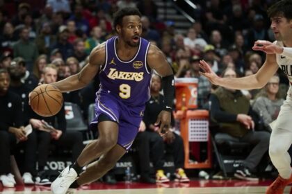Nov 3, 2025; Portland, Oregon, USA; Los Angeles Lakers guard Bronny James (9) drives to the basket during the second half against Portland Trail Blazers forward Deni Avdija (8) at Moda Center. Mandatory Credit: Troy Wayrynen-Imagn Images