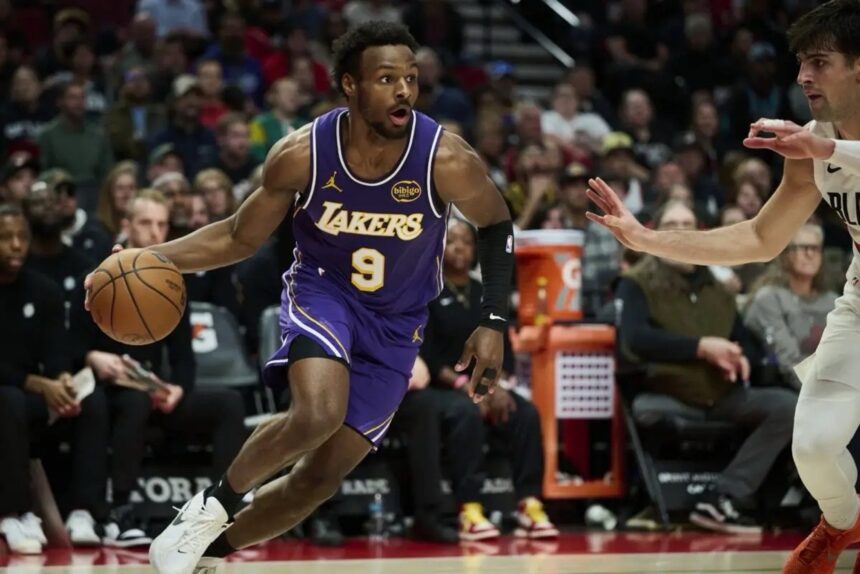 Nov 3, 2025; Portland, Oregon, USA; Los Angeles Lakers guard Bronny James (9) drives to the basket during the second half against Portland Trail Blazers forward Deni Avdija (8) at Moda Center. Mandatory Credit: Troy Wayrynen-Imagn Images