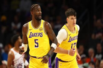 Oct 14, 2025; Phoenix, Arizona, USA; Los Angeles Lakers center Deandre Ayton (5) and forward Jake LaRavia (12) against the Phoenix Suns during an NBA preseason game at Mortgage Matchup Center. Mandatory Credit: Mark J. Rebilas-Imagn Images