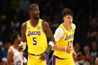 Oct 14, 2025; Phoenix, Arizona, USA; Los Angeles Lakers center Deandre Ayton (5) and forward Jake LaRavia (12) against the Phoenix Suns during an NBA preseason game at Mortgage Matchup Center. Mandatory Credit: Mark J. Rebilas-Imagn Images