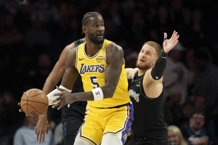 Los Angeles Lakers center Deandre Ayton (5) looks to pass the ball as Minnesota Timberwolves guard Donte DiVincenzo (0) plays defense in the first half at Target Center.