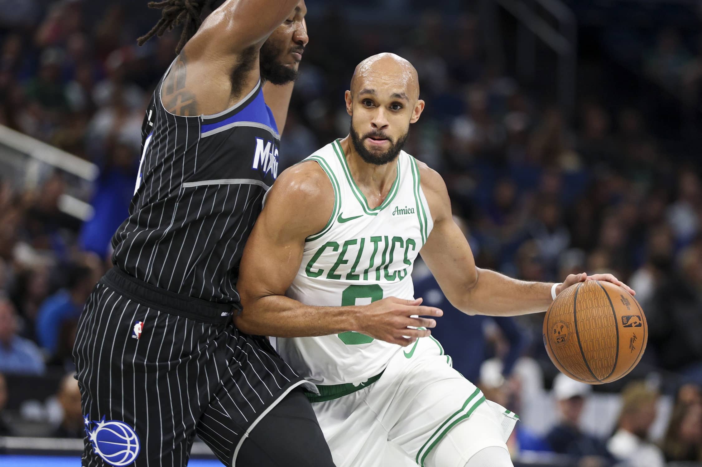 Boston Celtics guard Derrick White (9) drives to the basket past Orlando Magic center Wendell Carter Jr. (34) in the second quarter at Kia Center.