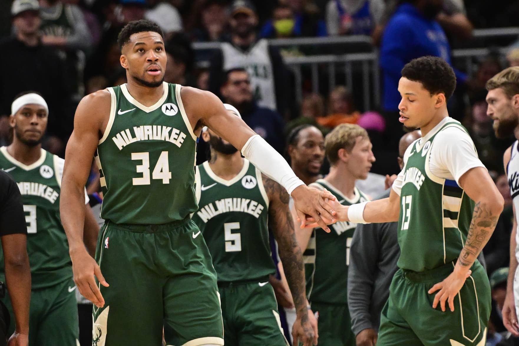 Milwaukee Bucks forward Giannis Antetokounmpo (34) reacts with guard Ryan Rollins (13) after scoring a basket in the 3rd quarter against the Sacramento Kings at Fiserv Forum.