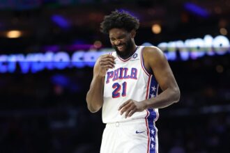 Philadelphia, Pennsylvania, USA; Philadelphia 76ers center Joel Embiid (21) laughs during a break in action in the first quarter against the Minnesota Timberwolves at Xfinity Mobile Arena. Mandatory Credit: Bill Streicher-Imagn Images