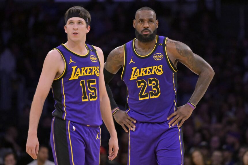 Los Angeles Lakers guard Austin Reaves (15) and forward LeBron James (23) talk on the court against the Brooklyn Nets at Crypto.com Arena.