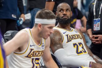 Apr 27, 2025; Minneapolis, Minnesota, USA; Los Angeles Lakers forward LeBron James (23) reacts to a replay that confirms he fouled Minnesota Timberwolves guard Anthony Edwards (5) in the fourth quarter during game four of first round for the 2025 NBA Playoffs at Target Center. Mandatory Credit: Matt Blewett-Imagn Images