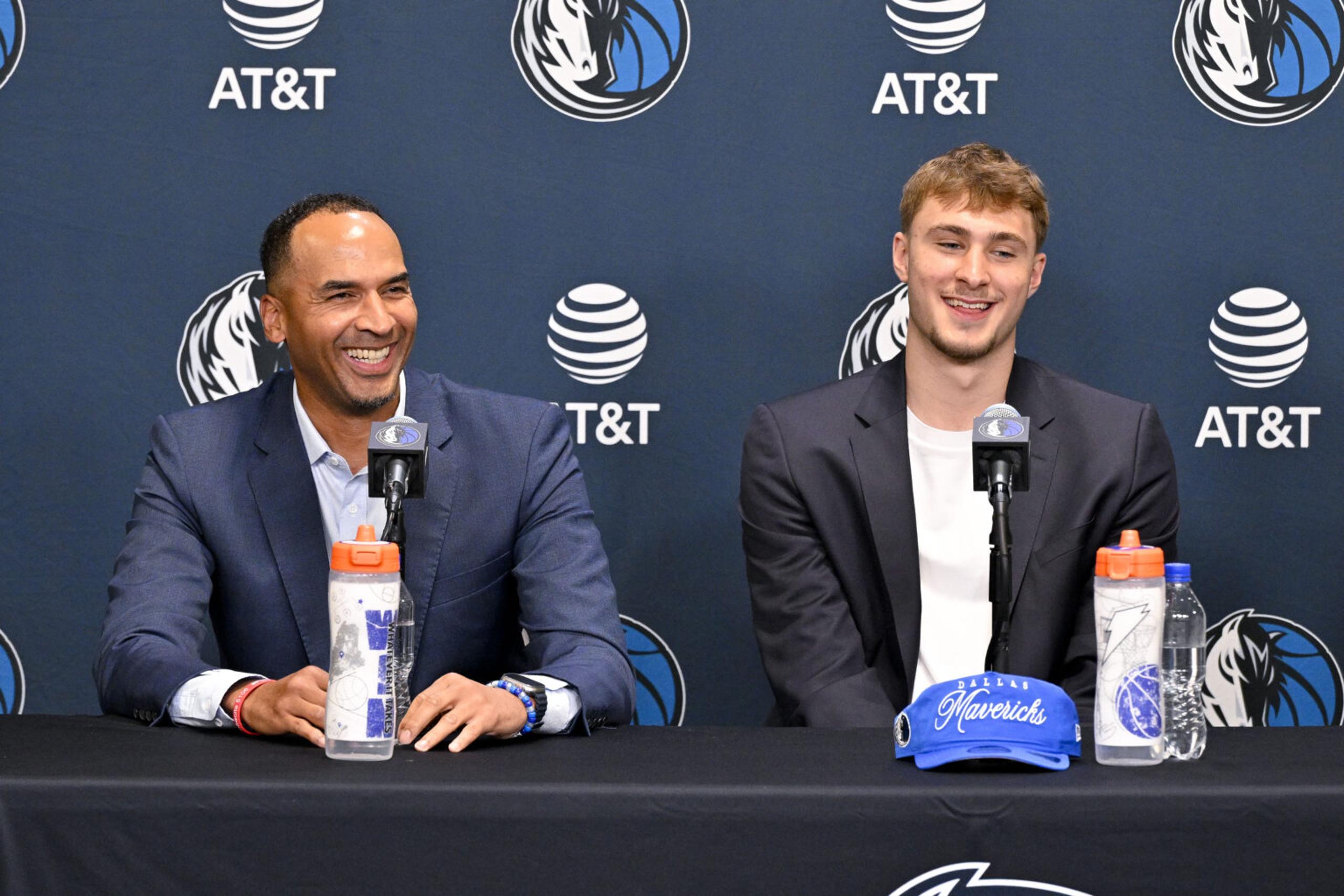 Jun 27, 2025; Dallas, TX, USA; Dallas Mavericks general manager Nico Harrison (left) looks on with Mavericks first overall pick Cooper Flagg (right) at a press conference at the Dallas Mavericks Practice Facility. Mandatory Credit: Jerome Miron-Imagn Images