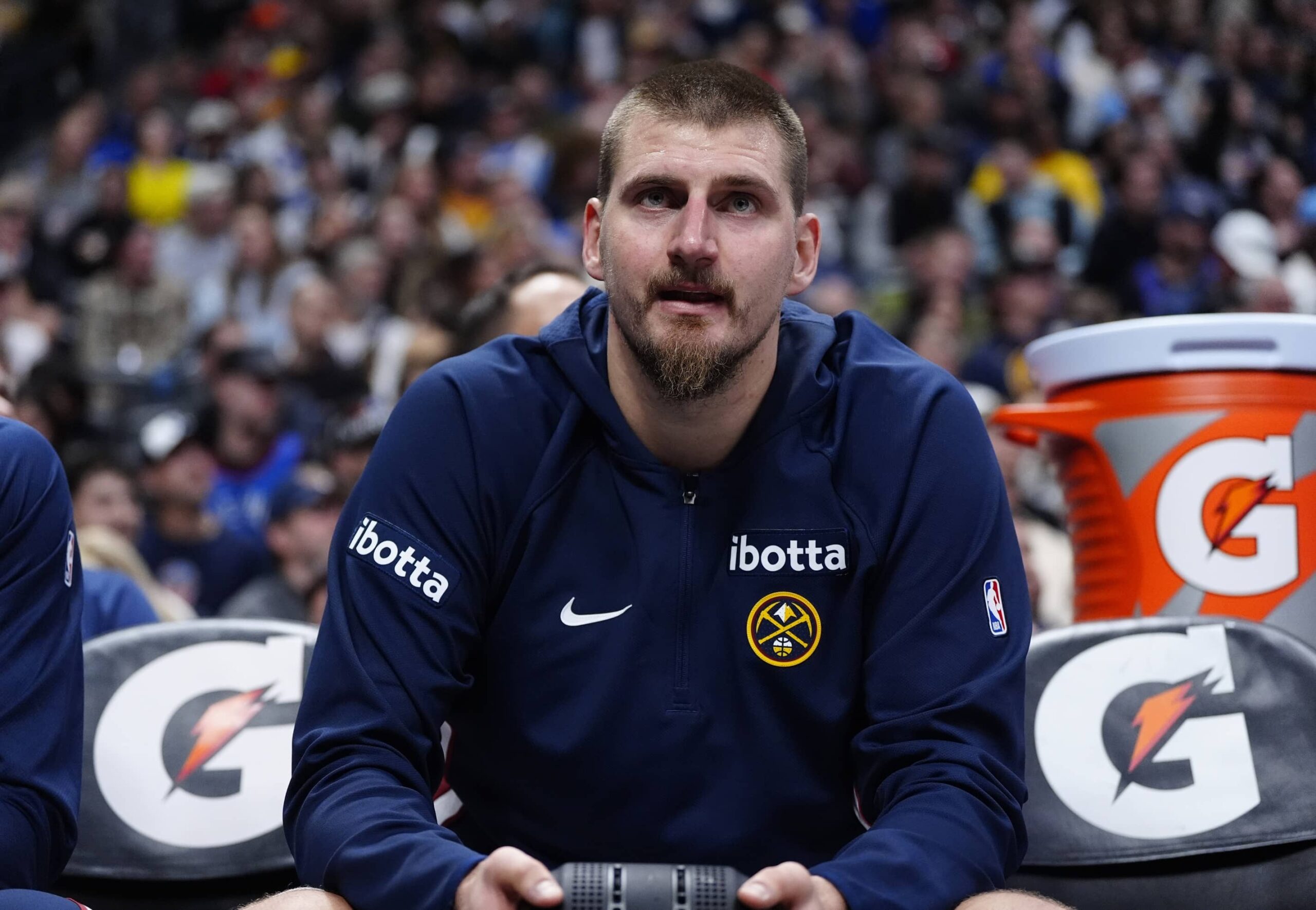 Denver Nuggets center Nikola Jokic (15) on the bench in the third quarter at Ball Arena.