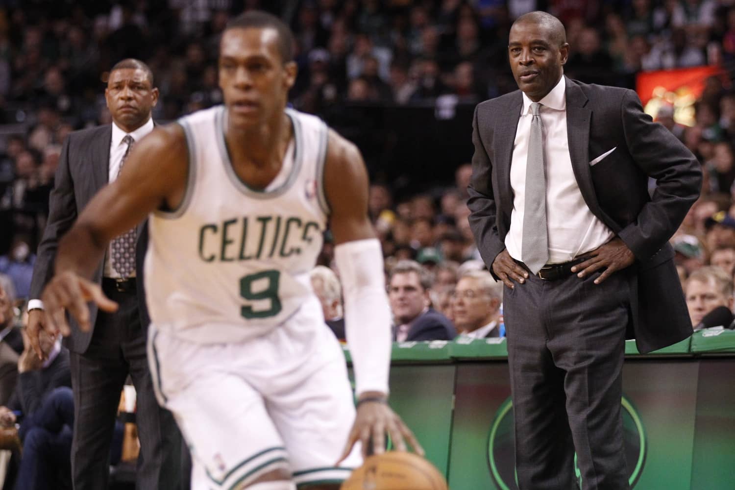 Atlanta Hawks head coach Larry Drew (right) and Boston Celtics head coach Doc Rivers (left) watch as Celtics point guard Rajon Rondo (9) drives the ball in the second half at the TD Banknorth Garden. The Celtics defeated the Atlanta Hawks 88-86 in overtime.