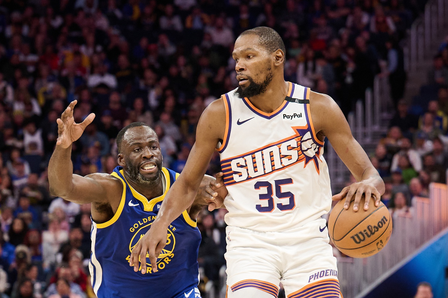 Dec 28, 2024; San Francisco, California, USA; Phoenix Suns forward Kevin Durant (35) controls the ball against Golden State Warriors forward Draymond Green (23) during the third quarter at Chase Center. Mandatory Credit: Robert Edwards-Imagn Images