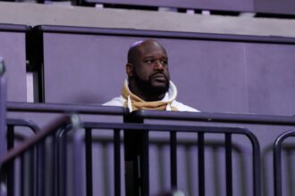 Gainesville, Florida, USA; Former NBA player Shaquille O'Neal sits courtside during the first half between the Florida Gators and the LSU Tigers at Exactech Arena at the Stephen C. O'Connell Center. Mandatory Credit: Matt Pendleton-Imagn Images