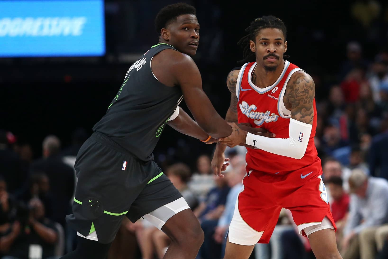 Apr 10, 2025; Memphis, Tennessee, USA; Minnesota Timberwolves guard Anthony Edwards (5) and Memphis Grizzlies guard Ja Morant (12) battle for position during the third quarter at FedExForum. Mandatory Credit: Petre Thomas-Imagn Images