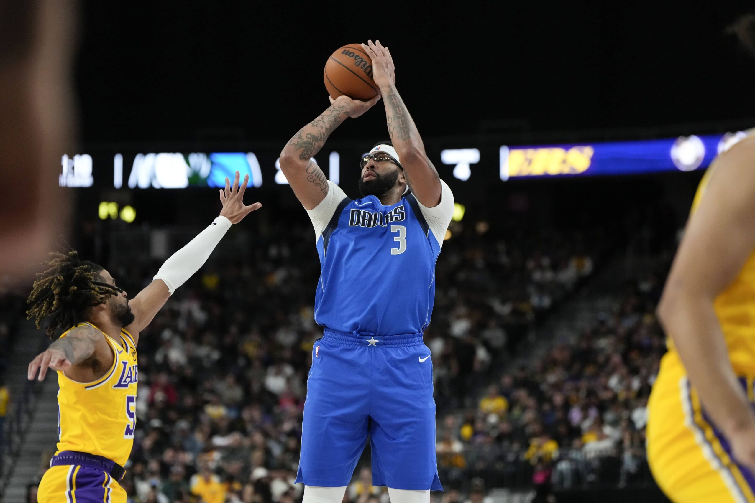 Oct 15, 2025; Las Vegas, Nevada, USA; Dallas Mavericks forward Anthony Davis (3) shoots the ball against Los Angeles Lakers guard R.J. Davis (55) during the first half at T-Mobile Arena. Mandatory Credit: Lucas Peltier-Imagn Images
