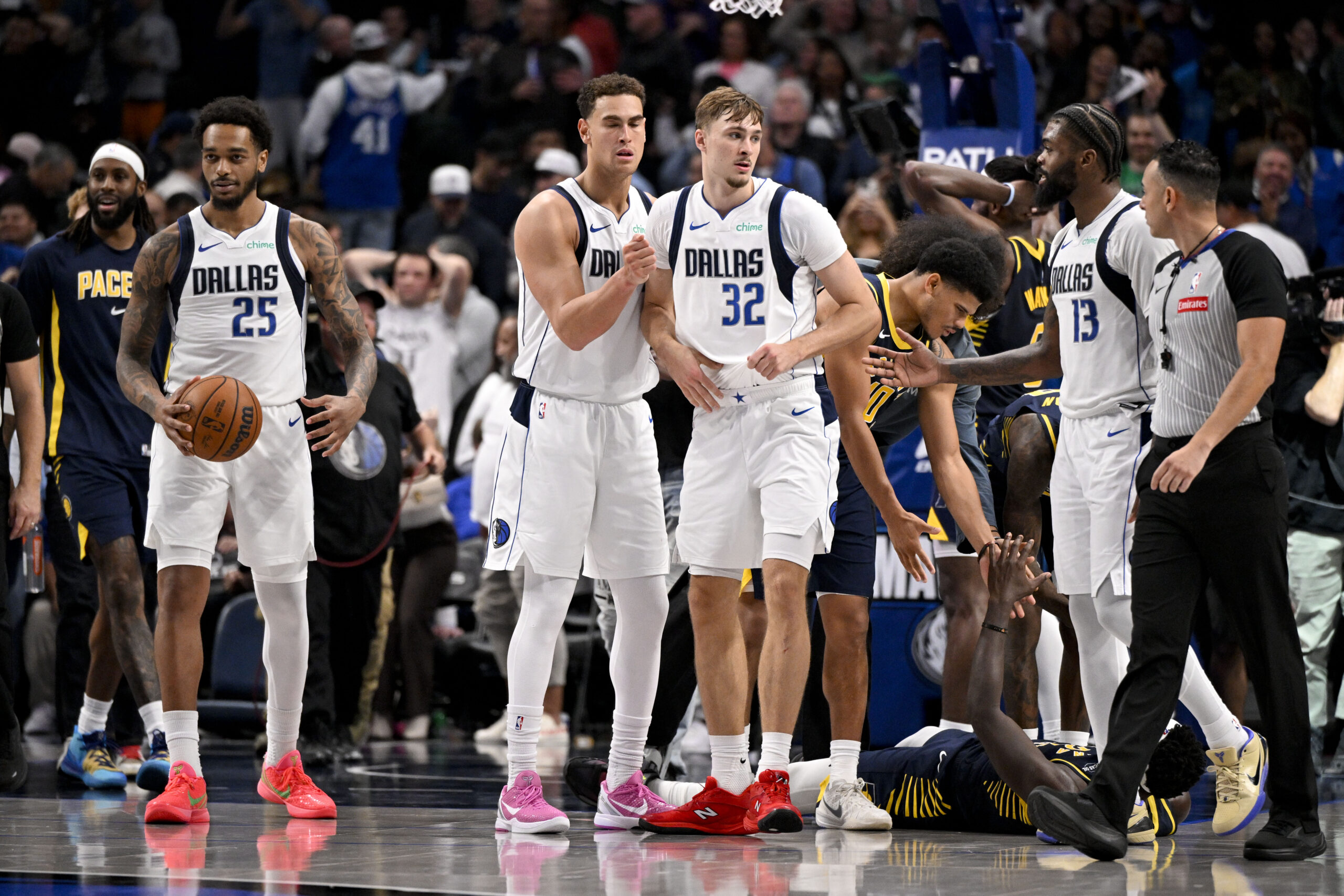 Oct 29, 2025; Dallas, Texas, USA; Dallas Mavericks forward P.J. Washington (25) and forward Dwight Powell (7) and forward Cooper Flagg (32) and forward Naji Marshall (13) react to the win over the Indiana Pacers at the American Airlines Center. Mandatory Credit: Jerome Miron-Imagn Images