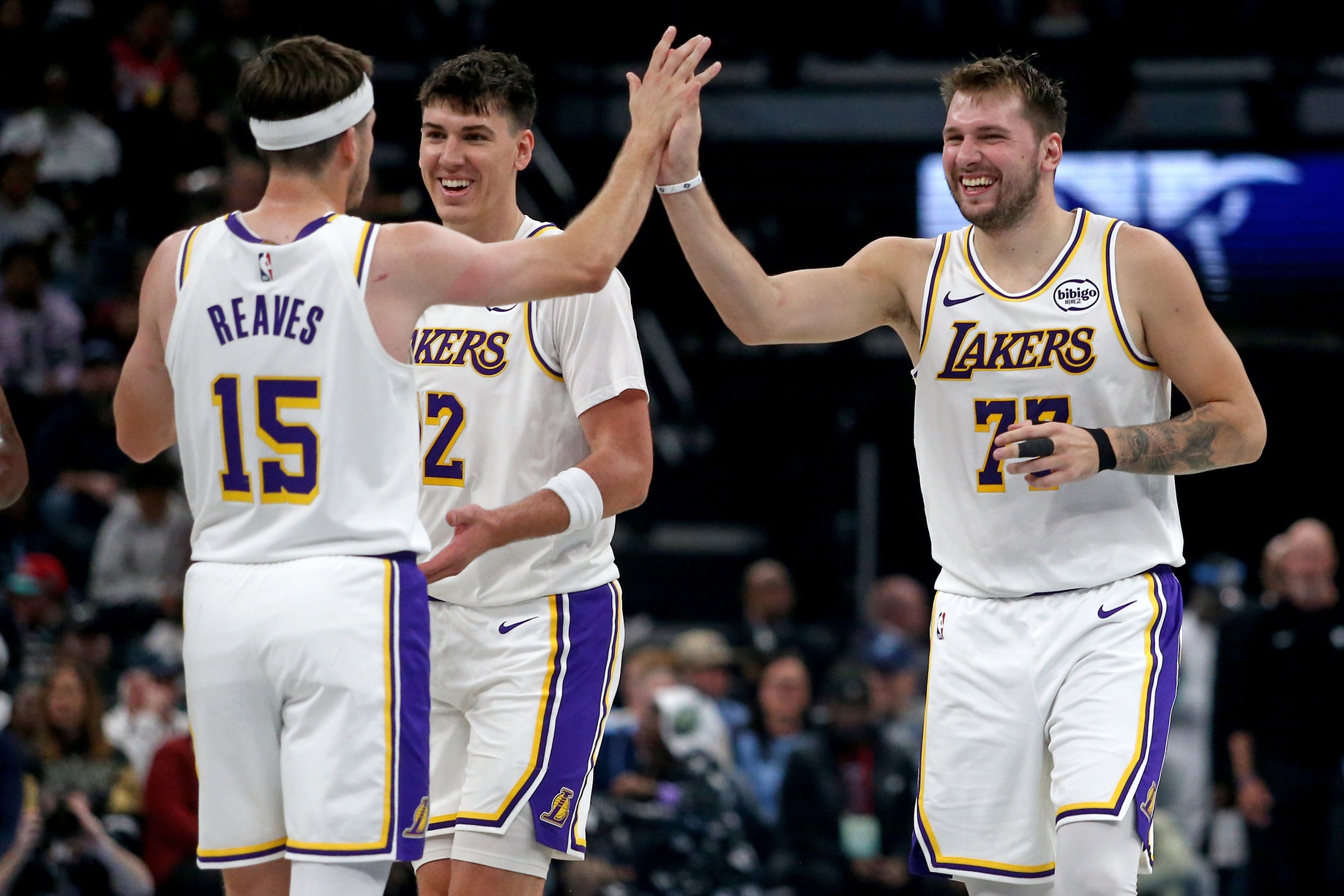 Oct 31, 2025; Memphis, Tennessee, USA; Los Angeles Lakers guard Luka Doncic (77) reacts with guard Austin Reaves (15) during a timeout during the second quarter against the Memphis Grizzlies at FedExForum. Mandatory Credit: Petre Thomas-Imagn Images