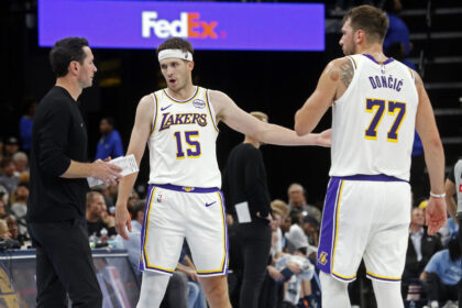 Oct 31, 2025; Memphis, Tennessee, USA; Los Angeles Lakers head coach JJ Redick talks with guard Austin Reaves (15) and guard Luka Doncic (77) during the fourth quarter against the Memphis Grizzlies at FedExForum. Mandatory Credit: Petre Thomas-Imagn Images