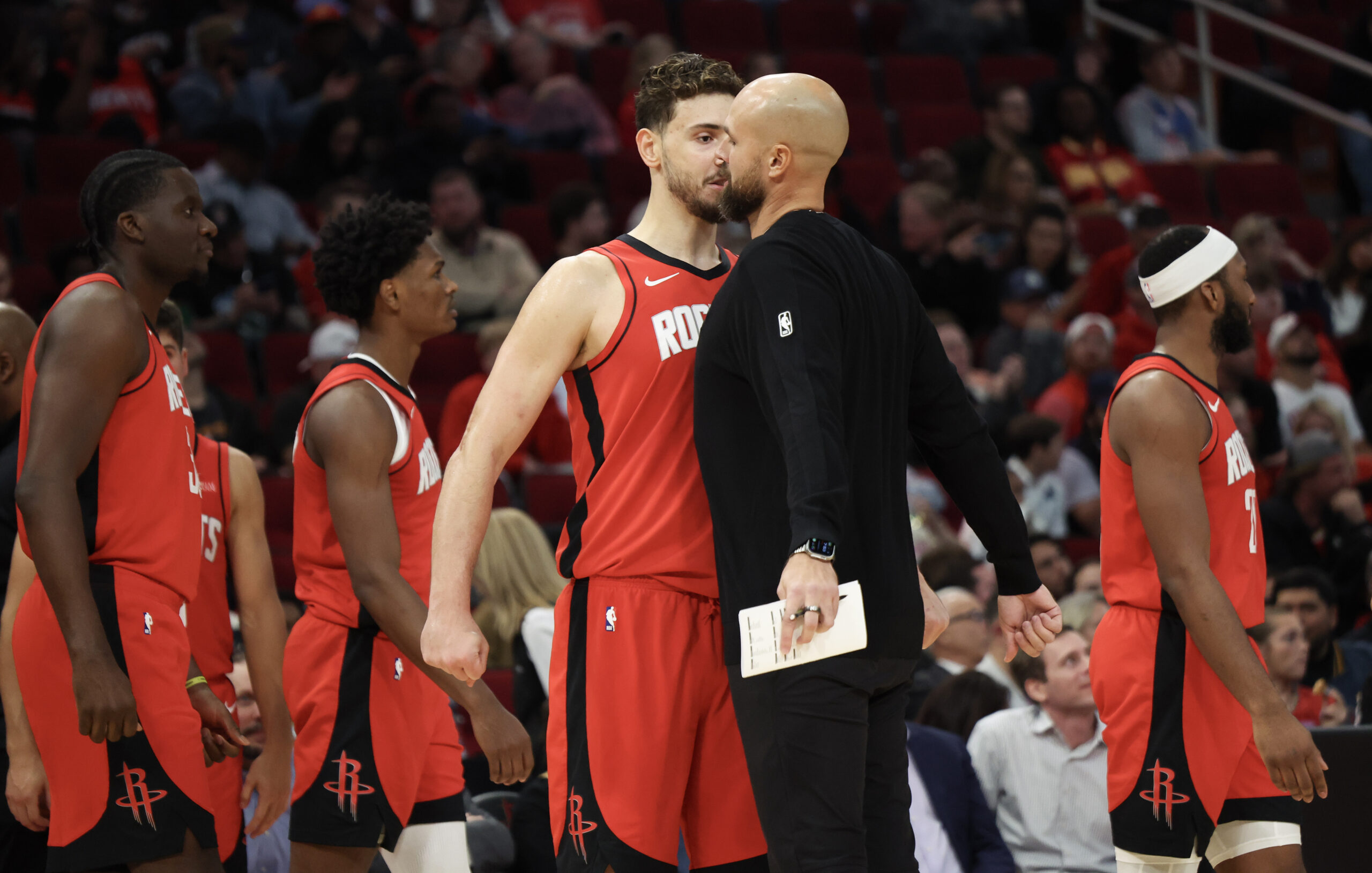 Nov 3, 2025; Houston, Texas, USA; Houston Rockets center Alperen Sengun (28) chest bumps assistant coach Vince Sullivan during a Dallas Mavericks timeout in the second quarter at Toyota Center. Mandatory Credit: Thomas Shea-Imagn Images