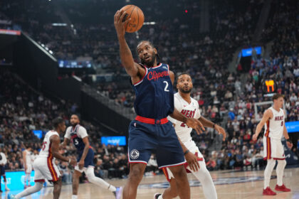 Nov 3, 2025; Inglewood, California, USA; LA Clippers forward Kawhi Leonard (2) reaches for the ball against Miami Heat guard Norman Powell (24) in the first half at Intuit Dome. Mandatory Credit: Kirby Lee-Imagn Images