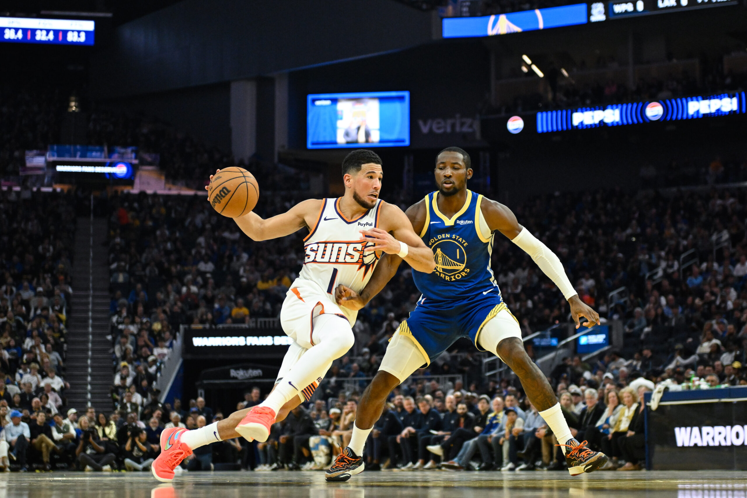 Nov 4, 2025; San Francisco, California, USA; Phoenix Suns guard Devin Booker (1) drives to the basket against Golden State Warriors forward Jonathan Kuminga (1) in the second quarter at Chase Center. Mandatory Credit: Eakin Howard-Imagn Images