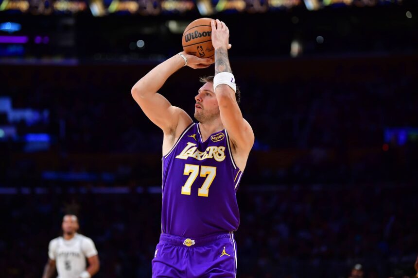 Nov 5, 2025; Los Angeles, California, USA; Los Angeles Lakers guard Luka Doncic (77) shoots against the San Antonio Spurs during the first half at Crypto.com Arena. Mandatory Credit: Gary A. Vasquez-Imagn Images