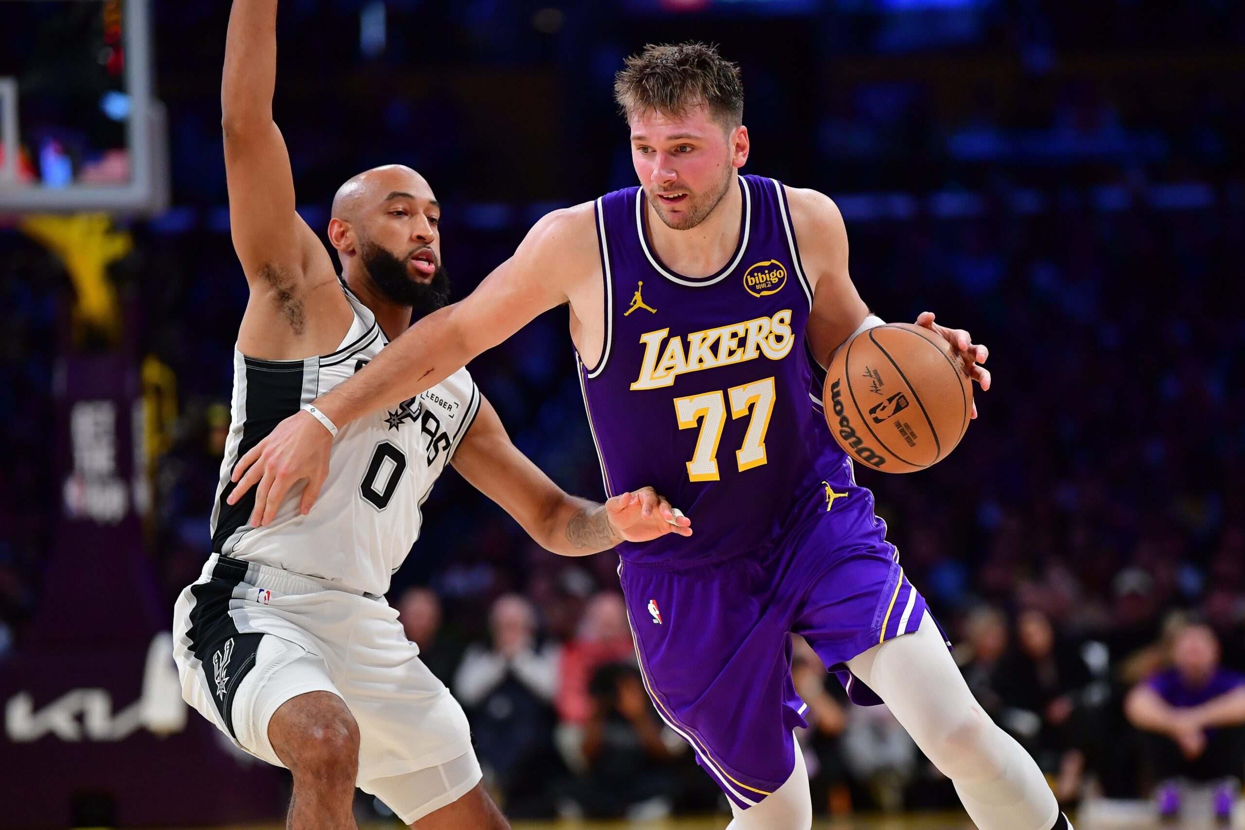Nov 5, 2025; Los Angeles, California, USA; Los Angeles Lakers guard Luka Doncic (77) moves the ball against San Antonio Spurs guard Jordan McLaughlin (0) during the first half at Crypto.com Arena. Mandatory Credit: Gary A. Vasquez-Imagn Images